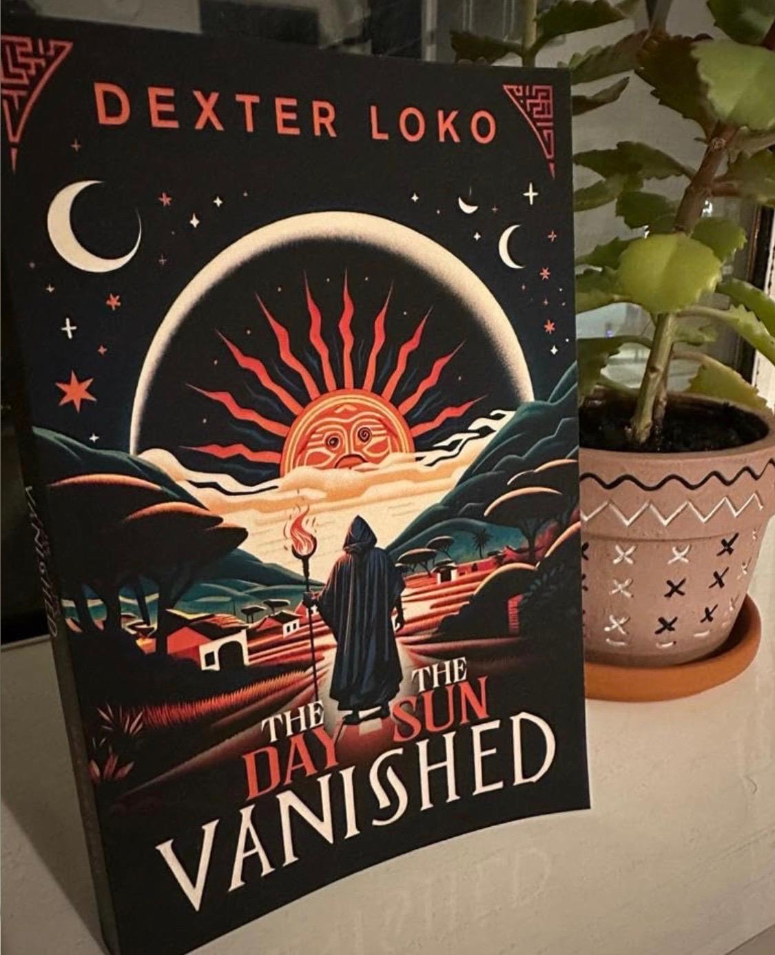 A copy of The Day the Sun Vanished standing beside a potted plant.