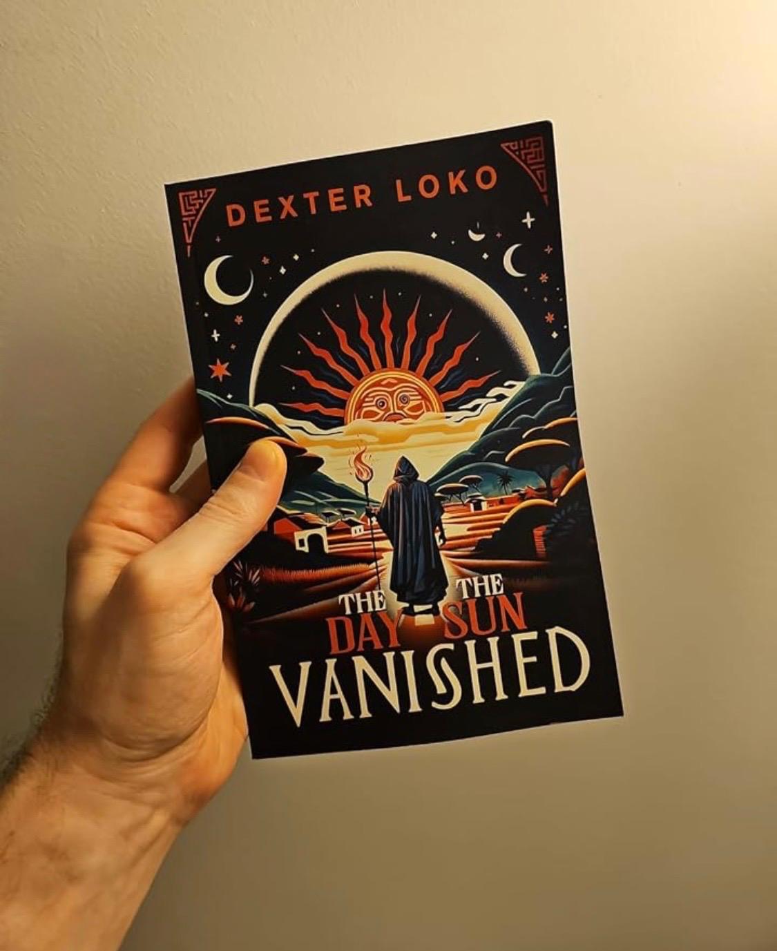 A hand holding a copy of The Day the Sun Vanished against a warm wall.